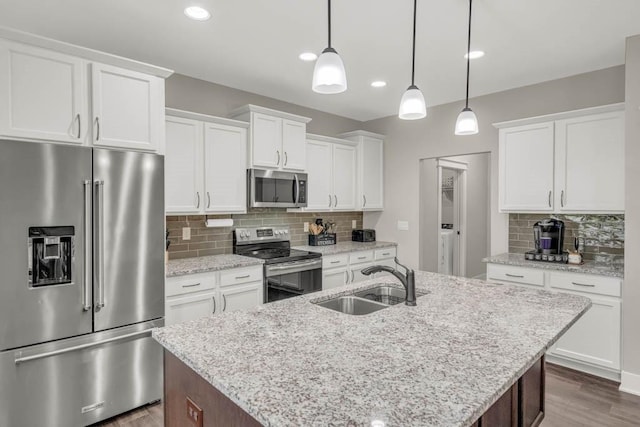 3911 NW 14th Ct, Ankeny, IA 50023 - kitchen with appliances with stainless steel finishes, a sink, dark wood-style flooring, tasteful backsplash, and a center island with sink