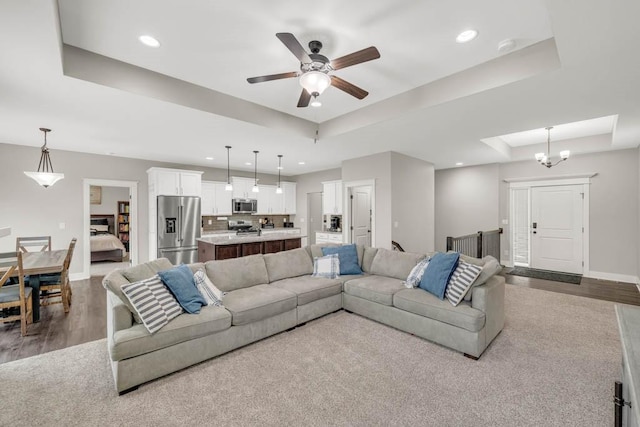 3911 NW 14th Ct, Ankeny, IA 50023 - living room with a raised ceiling, wood finished floors, recessed lighting, a ceiling fan, and baseboards