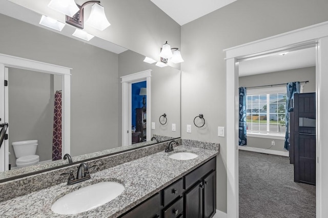 3911 NW 14th Ct, Ankeny, IA 50023 - full bath with toilet, double vanity, and baseboards
