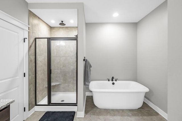3911 NW 14th Ct, Ankeny, IA 50023 - full bathroom featuring baseboards, a stall shower, a freestanding bath, vanity, and recessed lighting