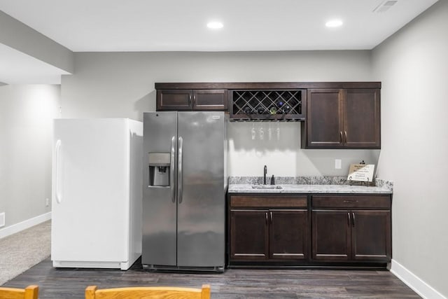 3911 NW 14th Ct, Ankeny, IA 50023 - kitchen featuring stainless steel refrigerator with ice dispenser, freestanding refrigerator, a sink, dark brown cabinetry, and recessed lighting