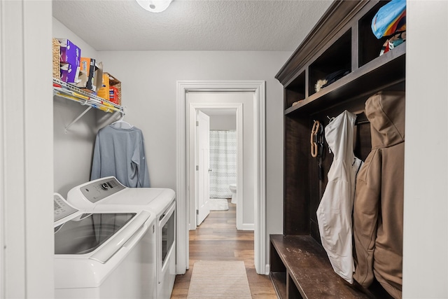 2320 SE Maxwell Dr, Waukee, IA 50263 - laundry room with separate washer and dryer, light wood-type flooring, and a textured ceiling