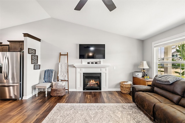 2320 SE Maxwell Dr, Waukee, IA 50263 - living room with lofted ceiling, dark wood finished floors, ceiling fan, a glass covered fireplace, and baseboards