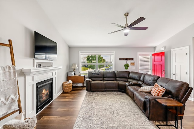 2320 SE Maxwell Dr, Waukee, IA 50263 - living area featuring lofted ceiling, a ceiling fan, wood finished floors, and a glass covered fireplace