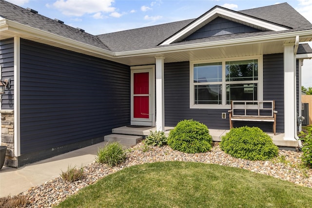 2320 SE Maxwell Dr, Waukee, IA 50263 - property entrance with roof with shingles and a lawn
