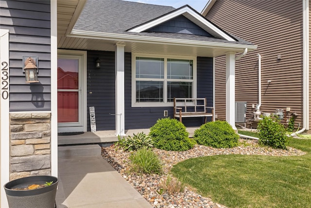2320 SE Maxwell Dr, Waukee, IA 50263 - entrance to property featuring roof with shingles, covered porch, and stone siding