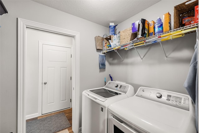 2320 SE Maxwell Dr, Waukee, IA 50263 - laundry room with separate washer and dryer, light wood-style floors, and a textured ceiling