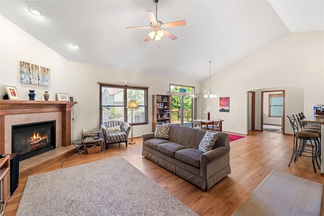 6814 Aubrey Ct, Johnston, IA 50131 - living room with ceiling fan, a fireplace, wood finished floors, high vaulted ceiling, and baseboards