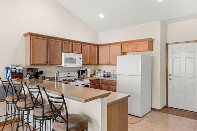6814 Aubrey Ct, Johnston, IA 50131 - kitchen featuring white appliances, a peninsula, high vaulted ceiling, light countertops, and brown cabinetry
