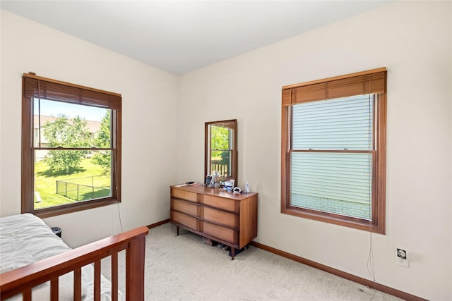 6814 Aubrey Ct, Johnston, IA 50131 - bedroom with light colored carpet, multiple windows, and baseboards