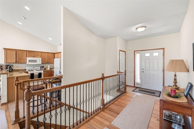 6814 Aubrey Ct, Johnston, IA 50131 - entryway featuring light wood finished floors and vaulted ceiling