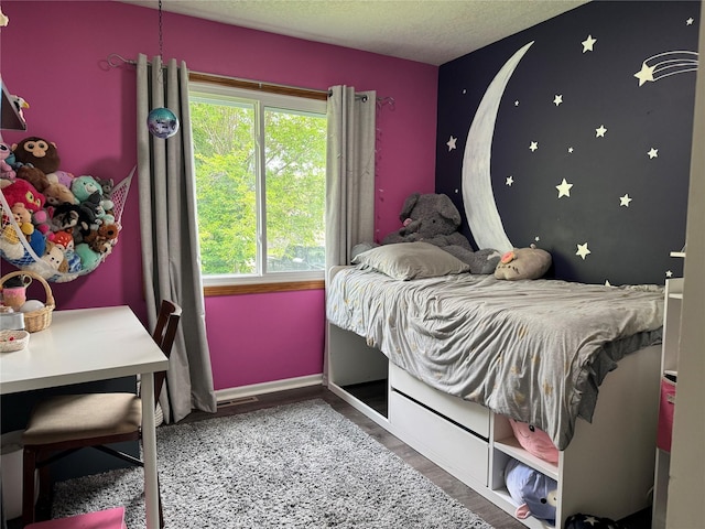 2520 NW 14th St, Ankeny, IA 50023 - bedroom featuring wood finished floors and a textured ceiling
