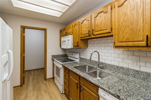 4400 Ep True Pkwy Unit 4, West Des Moines, IA 50265 - kitchen with white appliances, a sink, light wood-style flooring, backsplash, and stone counters