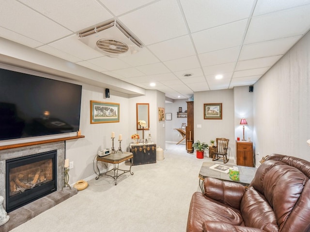 812 W 2nd St S, Newton, IA 50208 - carpeted living room featuring a glass covered fireplace, a paneled ceiling, and recessed lighting