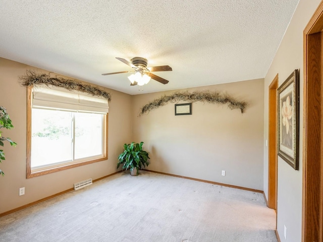 812 W 2nd St S, Newton, IA 50208 - unfurnished room with ceiling fan, a textured ceiling, baseboards, and light colored carpet