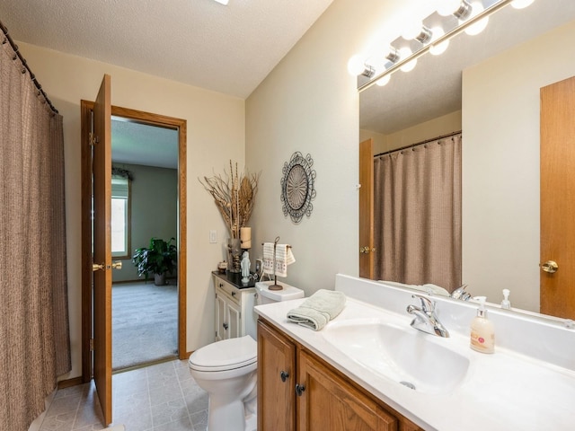 812 W 2nd St S, Newton, IA 50208 - bathroom with vanity, toilet, and tile patterned floors