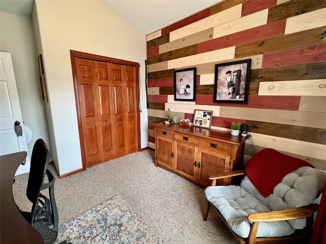 1008 Pine Brooke Ct, Clear Lake, IA 50428 - sitting room with wood walls, carpet flooring, and lofted ceiling