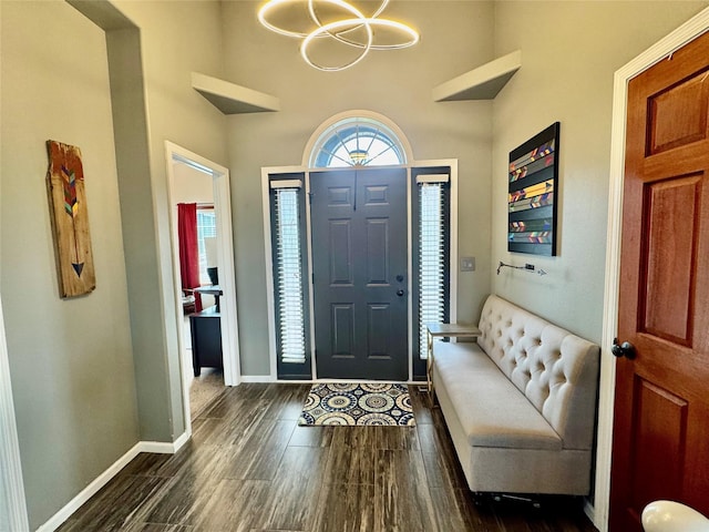 1008 Pine Brooke Ct, Clear Lake, IA 50428 - entryway with a chandelier, dark wood-style flooring, baseboards, and a towering ceiling
