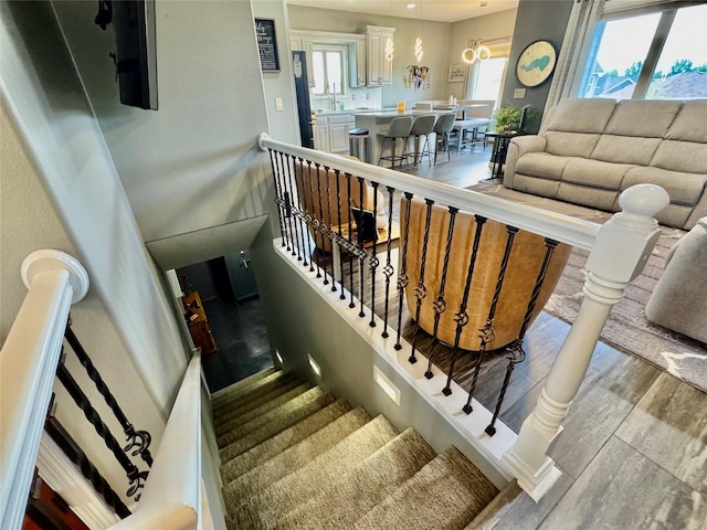1008 Pine Brooke Ct, Clear Lake, IA 50428 - staircase featuring wood finished floors