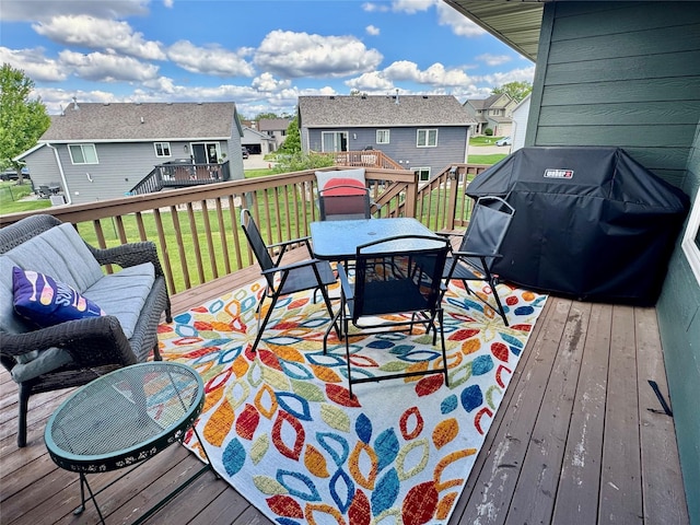 1008 Pine Brooke Ct, Clear Lake, IA 50428 - deck featuring a residential view, outdoor dining space, a yard, stairs, and area for grilling