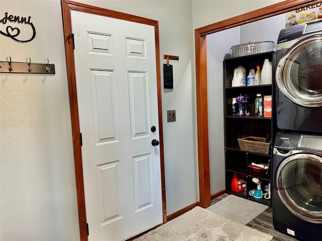 1008 Pine Brooke Ct, Clear Lake, IA 50428 - laundry room featuring estacked washer and dryer, wood finished floors, and baseboards