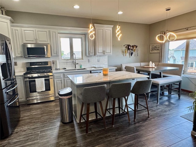 1008 Pine Brooke Ct, Clear Lake, IA 50428 - kitchen with stainless steel appliances, a sink, healthy amount of natural light, backsplash, and recessed lighting