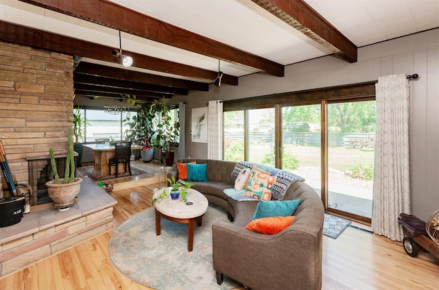 201 Jet St SW, Mitchellville, IA 50169 - living room featuring beamed ceiling, wood finished floors, and healthy amount of natural light