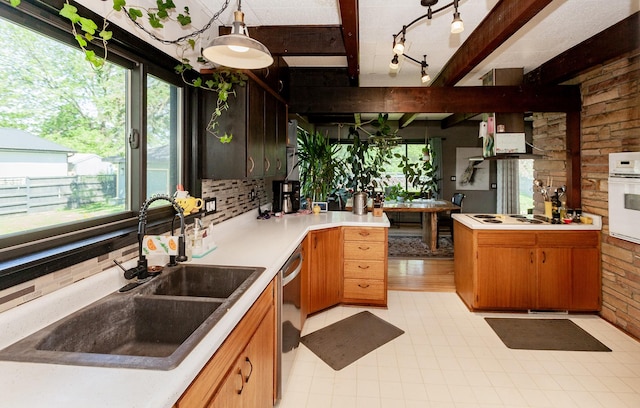 201 Jet St SW, Mitchellville, IA 50169 - kitchen featuring a sink, oven, stainless steel dishwasher, healthy amount of natural light, and beamed ceiling