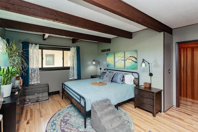 201 Jet St SW, Mitchellville, IA 50169 - bedroom featuring light wood-style floors and beam ceiling