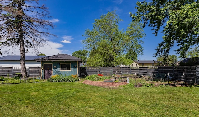201 Jet St SW, Mitchellville, IA 50169 - view of yard featuring a vegetable garden and an outdoor structure