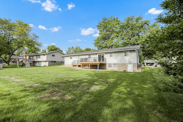 216 E 9th St, Pella, IA 50219 - rear view of house with a wooden deck and a yard
