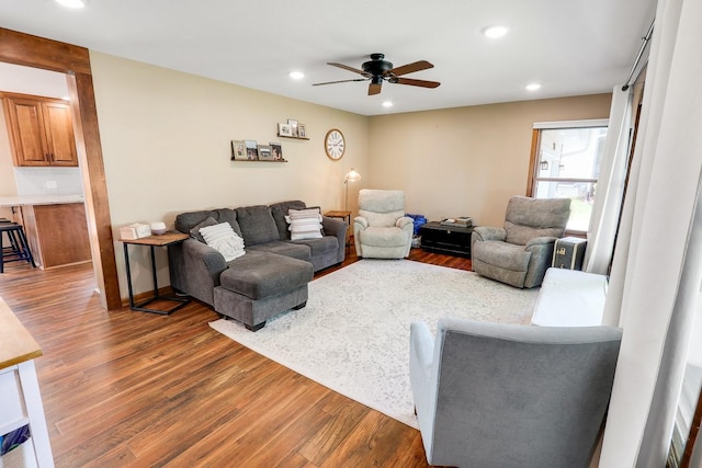 216 E 9th St, Pella, IA 50219 - living room featuring wood finished floors, a ceiling fan, and recessed lighting