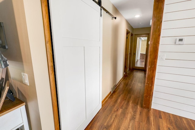 216 E 9th St, Pella, IA 50219 - hallway featuring dark wood-style floors, a barn door, and recessed lighting