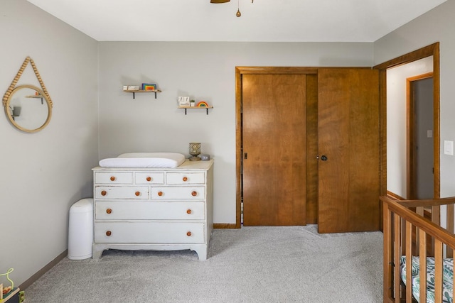 216 E 9th St, Pella, IA 50219 - bedroom with light colored carpet, baseboards, and a closet