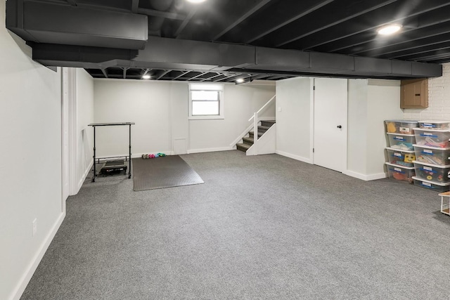 216 E 9th St, Pella, IA 50219 - below grade area featuring stairway, carpet floors, and baseboards