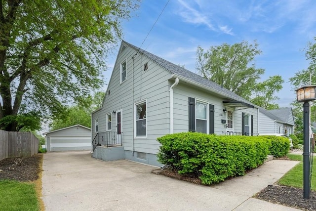 6100 College Ave, Des Moines, IA 50322 - view of property exterior featuring an outbuilding, a garage, and roof with shingles