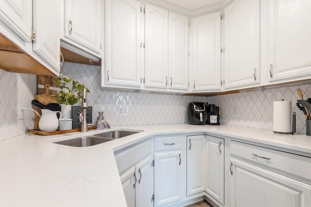 6100 College Ave, Des Moines, IA 50322 - kitchen with white cabinets, backsplash, light countertops, and a sink