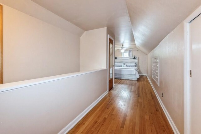 6100 College Ave, Des Moines, IA 50322 - hall with hardwood / wood-style flooring, vaulted ceiling, and baseboards