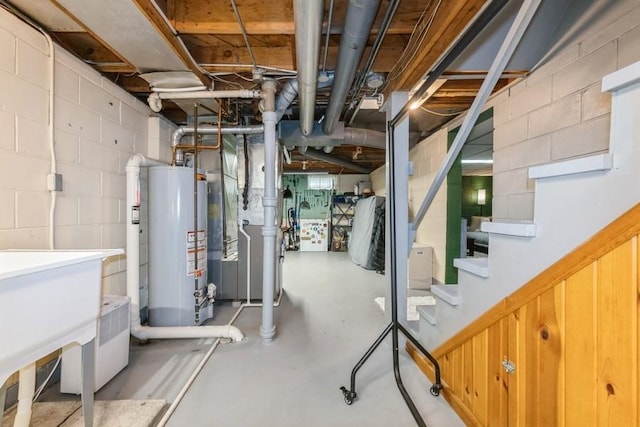 6100 College Ave, Des Moines, IA 50322 - unfinished basement with gas water heater, concrete block wall, and stairway