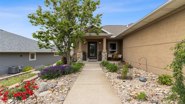 510 Lexington Dr, Clear Lake, IA 50428 - doorway to property with central AC and roof with shingles