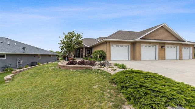 510 Lexington Dr, Clear Lake, IA 50428 - view of front facade featuring concrete driveway, a front yard, an attached garage, central AC, and stucco siding