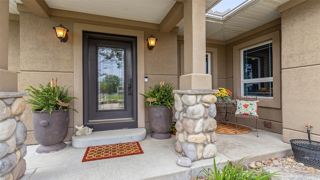 510 Lexington Dr, Clear Lake, IA 50428 - view of exterior entry with stucco siding and covered porch