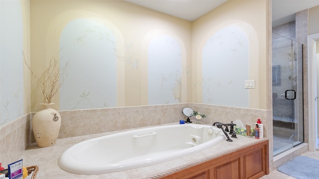 510 Lexington Dr, Clear Lake, IA 50428 - bathroom featuring a whirlpool tub and a stall shower