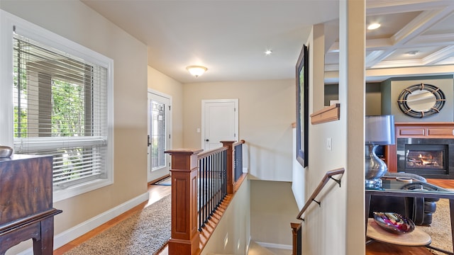 510 Lexington Dr, Clear Lake, IA 50428 - hall with an upstairs landing, baseboards, wood finished floors, beam ceiling, and coffered ceiling