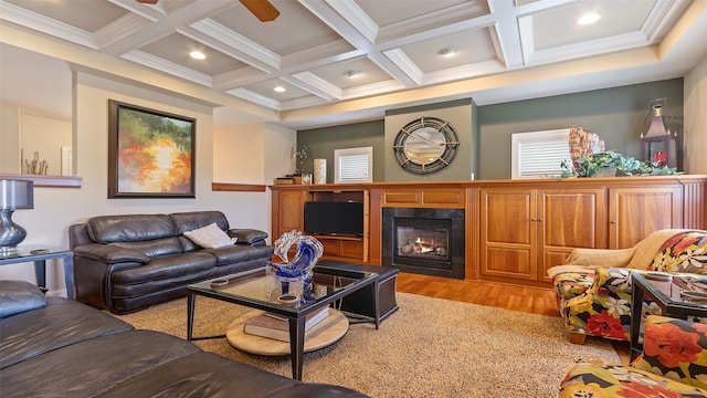 510 Lexington Dr, Clear Lake, IA 50428 - living area with coffered ceiling, light wood finished floors, beamed ceiling, a warm lit fireplace, and recessed lighting