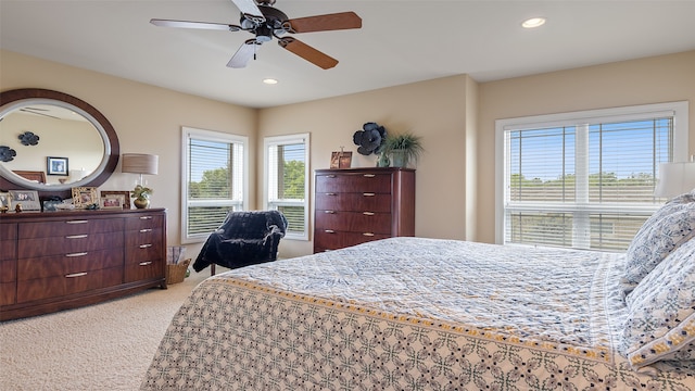 510 Lexington Dr, Clear Lake, IA 50428 - bedroom featuring light carpet, multiple windows, recessed lighting, and a ceiling fan