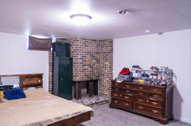 2326 E 39th Ct, Des Moines, IA 50317 - bedroom with a textured ceiling, a brick fireplace, and carpet floors