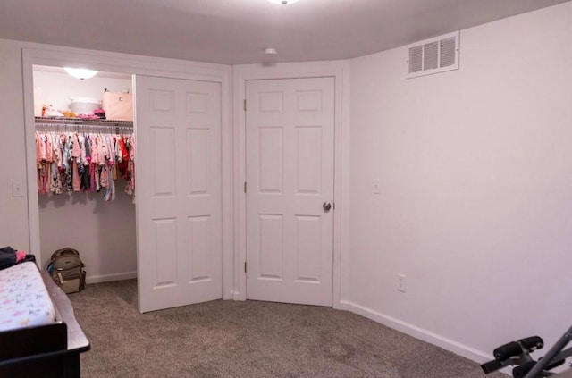 2326 E 39th Ct, Des Moines, IA 50317 - bedroom with carpet floors, a closet, a walk in closet, and baseboards