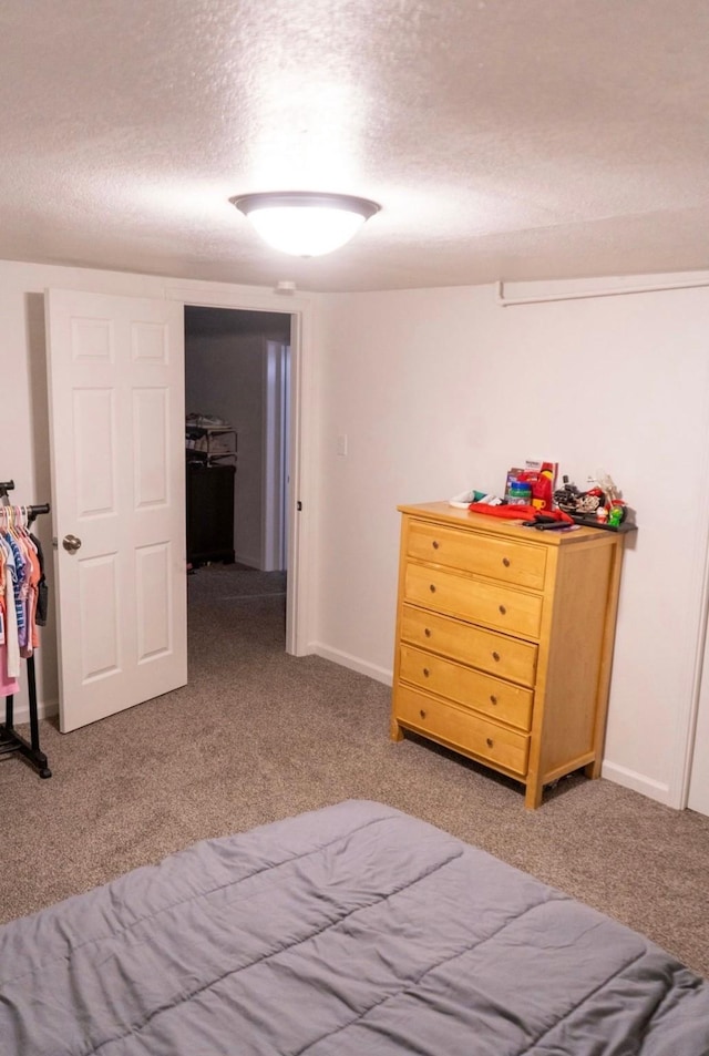 2326 E 39th Ct, Des Moines, IA 50317 - bedroom with a textured ceiling, light carpet, and baseboards