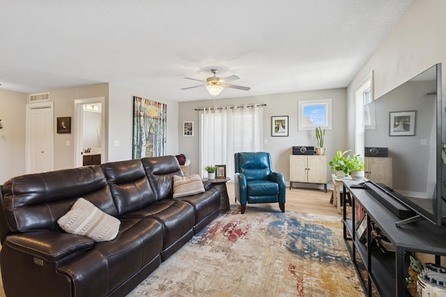 247 Red Oak Ct, Norwalk, IA 50211 - living room featuring a ceiling fan and wood finished floors
